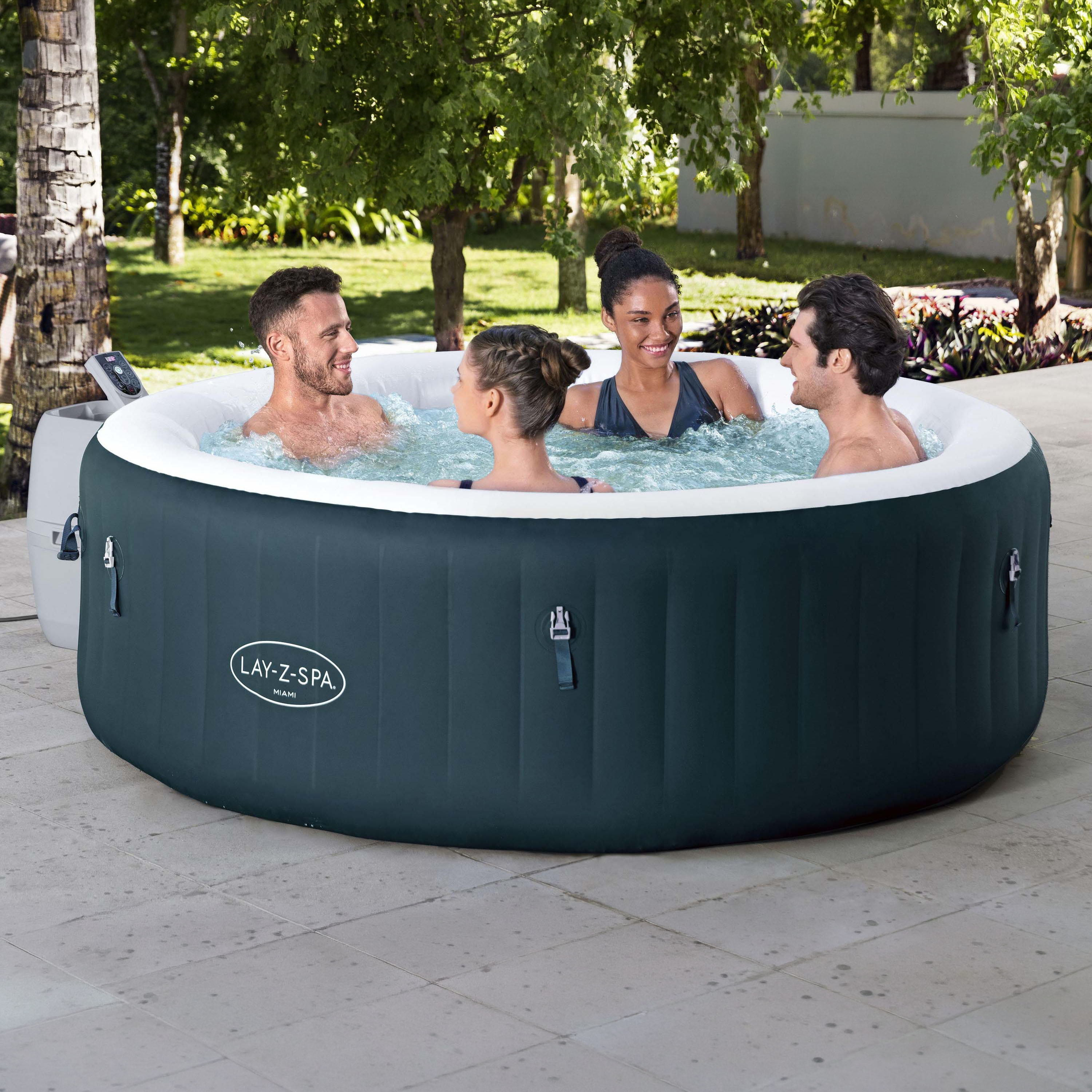 Okrągłe jacuzzi dmuchane Lay-Z-Spa Miami AirJet™ w kolorze ciemnozielonym z białym rantem na tarasie ogrodowym